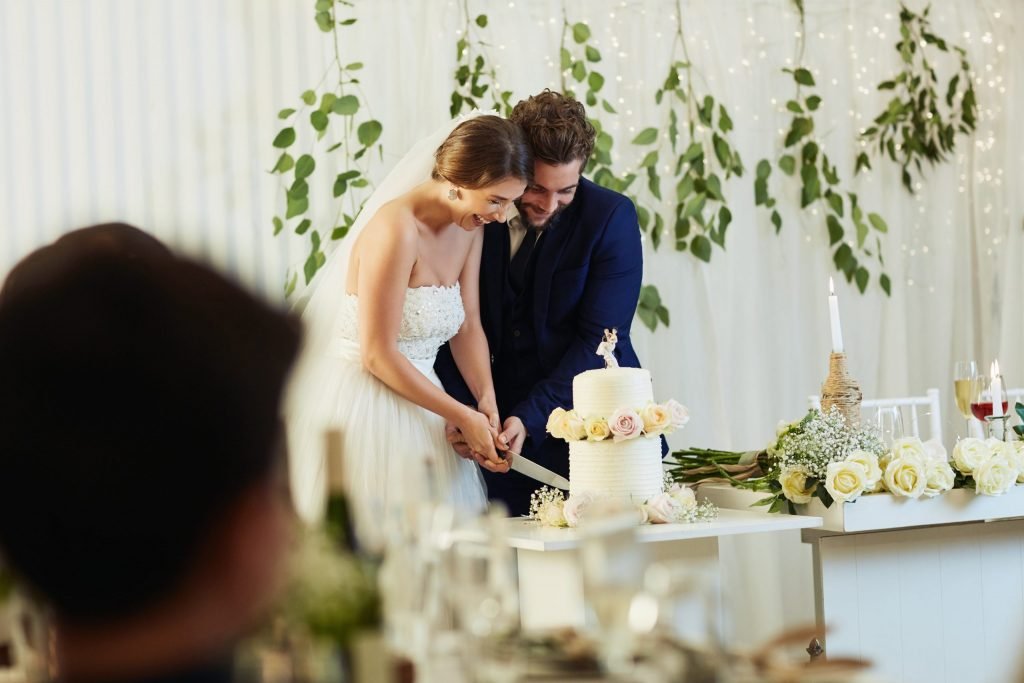 Shot of a middle aged couple cutting the cake at their wedding reception